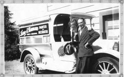 Larry Naumann and an unidentified girl, 1936 with his business van advertising Larry E. Naumann Painter & Decorator