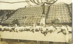 1910 Gravenstein Apple Show display by Ida S. Hunt and R. P. Hunt of plates of apples on a long table