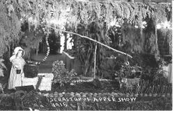 1915 Gravenstein Apple Show display with a girl manikin at a well made of apples