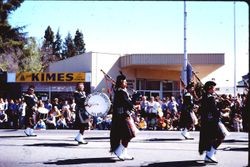 Sonoma County Sheriff's Pipe Band marching in the Apple Blossom Parade in the Apple Blossom Parade on North Main Street near McKinley Street, Sebastopol, California, 1970s