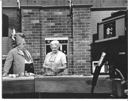 Mariam Hotle Burdo presenting an apple demonstration with an unidentified chef on a television cooking show on KNVT CBS, about 1960s