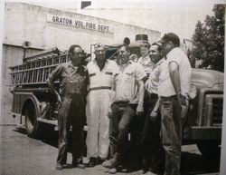 Five men and a young boy of the Graton Volunteer Fire Department stand in front of a firetruck