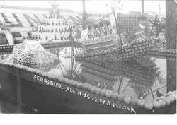 1912 Gravenstein Apple Show display of the sinking Titanic and an iceberg made of whole and dried sliced apples in a square pool of water