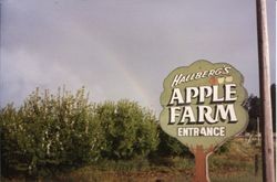 Hallberg Apple Farm fruit stand and bakery sign, with rainbow in background, about 1983