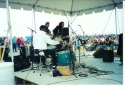 Band performing with audience seated on hay bales at the Fisherman's Festival in Bodega Bay, 1997