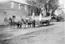 Four-horse drawn wagon hauling a lifeboat on Bodega Bay road in front of the Hotel, about 1908