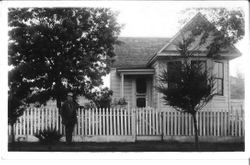 Unidentified man and woman in front of a west Sonoma County home, about early 1900s