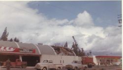 Wrecking crane begins demolishing the roof of Purity Market at the corner of McKinley and Main Streets in Sebastopol, about 1960