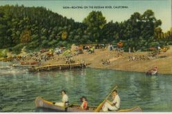 Russian River, California with bathers and boaters and sunbathers on the beach with sun umbrellas, 1930s