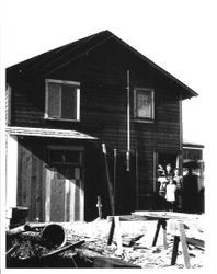 House in back of Paul's Market, Graton with Asian family of man and woman and two young girls, about 1930