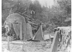 Loggers standing near or on top of a huge log on Alex Hendren's ranch, Willow Creek drainage, Glynn camp area, March, 1911