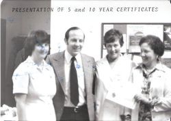 Dr. John Sweeney with 3 women receiving 5 & 10 year certificates, about 1970