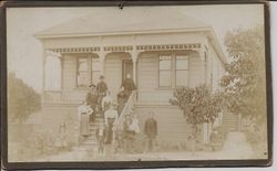 Borba family, adults and children, standing on the steps and front yard of a large house, 1880s or 1890s