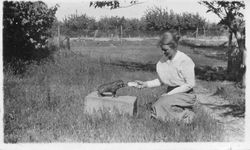 Della Hallberg feeding milk to a Duroc piglet