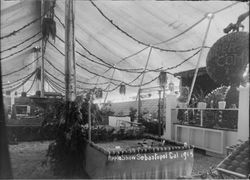 Gravenstein Apple Show exhibit, about 1914 in Sebastopol, showing display of apples under large tent
