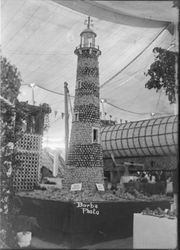 Gravenstein Apple Show 1913 exhibit in Sebastopol, showing display of a lighthouse made of apples under a large tent by the Jonive District