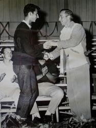 Unidentified student being congratulated by Walt Foster, head coach at the 1953 Analy High School athletics awards