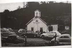 Watson School, Bodega, California with cars parked around the school for the retirement of longtime teacher Miss Margaret Witham, 1950