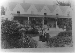 Elena O'Farrell, Frances Roche and Bessie Roche O'Farrell in summer hats and long skirts in front garden of the O'Farrell house at Analy Ranch in Freestone, California, 1890s