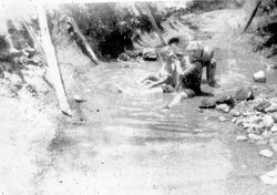 Three of the Elvy children playing in a creek on the Bonham Ranch, 1930s