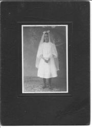 Studio portrait of unidentified girl in Confirmation dress