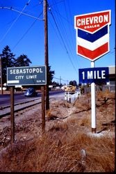 Sebastopol city limit sign (elevation 96 feet) and Chevron dealer sign on Gravenstein Highway South, Sebastopol, California, September 1970