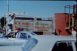 Building being torn down at corner of Burnett Street and South Main Street Sebastopol 1979. "Week's Hardware Co." and "The Winchester Store" and "W.S. Borba, The Stationer" "Victrolas" signs painted on side of adjacent building