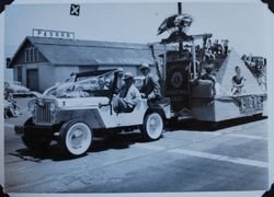 Henry Martin driving the Sebastopol Lions Club float in the Apple Blossom Parade, about 1955, with Carl Erickson in the left back (Sebastopol Lions Club scrapbook photo)