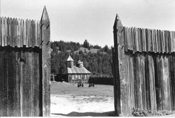 Chapel at Fort Ross California through the wooden gate of the fortress, about 2000