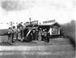 A. S. Huck stands in his JN4 "Jenny" biplane at the Analy Service Station in Sebastopol, 1920s