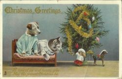 Christmas message with Christmas tree with dog and cat dressed in nightgowns