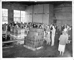 Cannery warehouse of O. A. Hallberg & Sons Apple Products cannery in Graton, California with the National Apple Institute (NAI) convention crowd in 1955