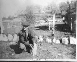 Bill Rich holding a cat, about 1915