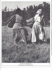 Pomo basket makers Susie Gomez and Essie Parrish carrying baskets on their backs in grassland