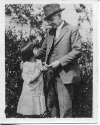 Luther Burbank with a small girl named Betty June, about 1920