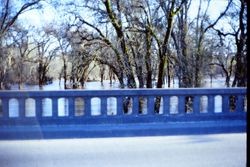 Bridge on Highway 12 over the Laguna de Santa Rosa flood plain at the eastern edge of Sebastopol with floodwaters below the roadway 1970s