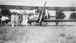 Women standing in front of the biplane at the American Legion airshow at Cnopius Field, Sebastopol, 1928