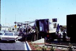 Workers putting the Pacific Fruit Express boxcar in place behind the West County Museum, August, 1982