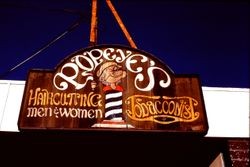 Hand-painted business sign of Popeye's Haircutting and Tobacconist at 217 North Main Street, Sebastopol, California