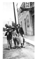 Bunni Streckfus standing next to two Mexican boys who appear to be selling trinkets in San Martin, Mexico, May 11, 1949