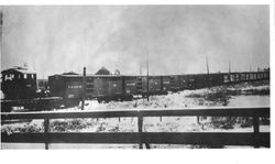 String of Petaluma and Santa Rosa Electric Railway (P&SR) boxcars being pulled by an engine