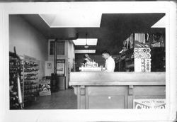 Delbert triggs at the counter in J. F Triggs & Son Auto parts store April, 1939 at 130 South Main Street, Sebastopol