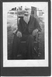 Hezikiah Hawn, Bunni Myers' maternal grandfather, seated in a rocking chair in a yard, Ravenna, Ohio