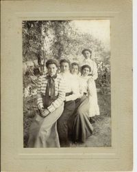 Group of five women, four seated and the fifth standing identified on back as: Julia Moll, Emily Moll, Eugene Moll, Miss Tamming and D. (Delphine) McChristian, August 20, 1899