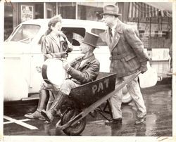 Charles Holme, Jr. (Sebastopol Cold Storage Co. manager,) pushing Art B. Sexton in a wheel barrow down Sebastopol Main Street--paying off an election bet during the Presidential election of 1940, Franklin D. Roosevelt vs Wendell Willkie