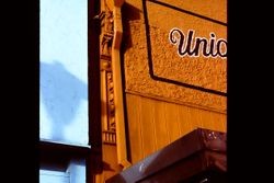 Cast iron column of the Unique Boutique at 150 North Main Street, Sebastopol, California, partially covered by the drain spout