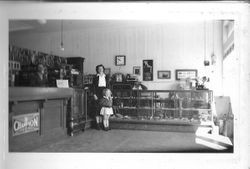 Raymond Smith, Mrs.Georgia Triggs and daughter at the J. F. Triggs & Son Auto parts store at 130 South Main Street Sebastopol