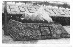 1915 Gravenstein Apple Show display with "Federated" spelled out in apples behind another display of apples
