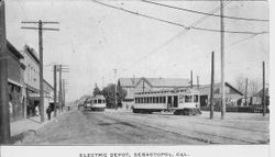 View looking north on Sebastopol's Main Street with three train cars of the Petaluma & Santa Rosa Railroad (P&SR) visible