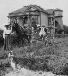 Melvin and Nellie DaVall and their son Roland Henry DaVall in their horse-drawn buggy, Melvin's mother, MaryChandler DaVall, and an unidentified woman in front of the DaVall home, about 1910 in Sebastopol